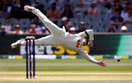 Josh Inglis dives for the ball during the third Test in Adelaide
