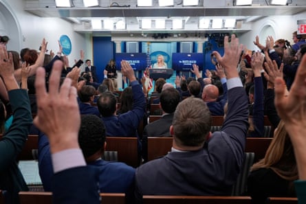 Journalists raise their hands to ask questions to Karoline Leavitt, the White House press secretary.