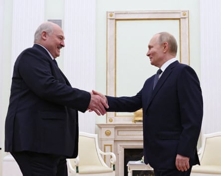Alexander Lukashenko shakes hands with Vladimir Putin during a meeting at the Kremlin in Moscow.