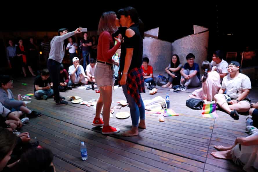 A Chinese couple kiss as they play games on a cruise organised by the Parents and Friends of Lesbians and Gays China as the ship leaves Sasebo in Nagasaki, Japan