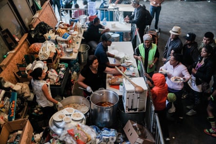 Photograph taken by Ariana Drehsler of volunteers feeding lunch to migrants from Central America at a shelter in Tijuana, Mexico, on 23 December 2018.