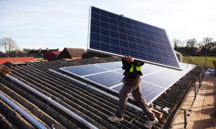 Solar panels are installed on a barn roof in West Sussex.