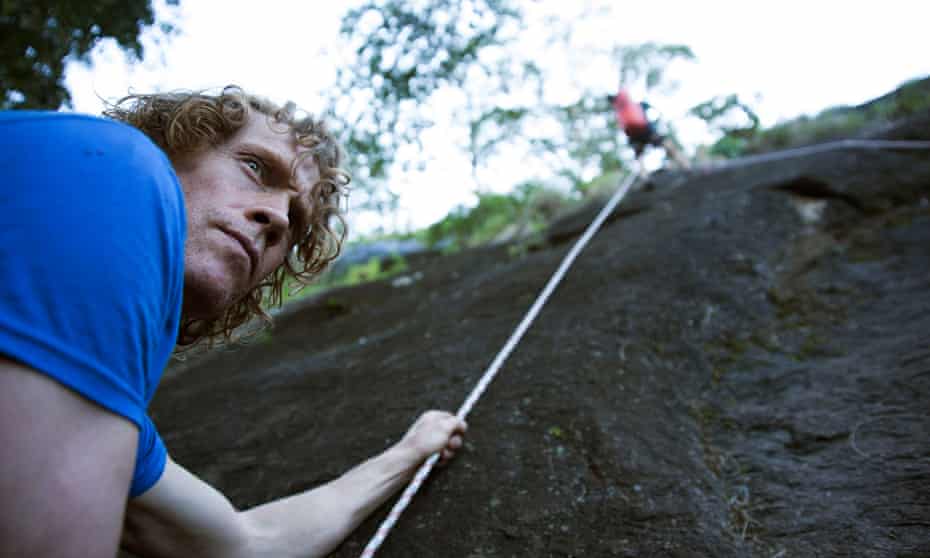 Julian Lines, left, and Mike Robertson, up the rope, prepare the way for the team to move up into Mount Lico’s mountaintop forest.