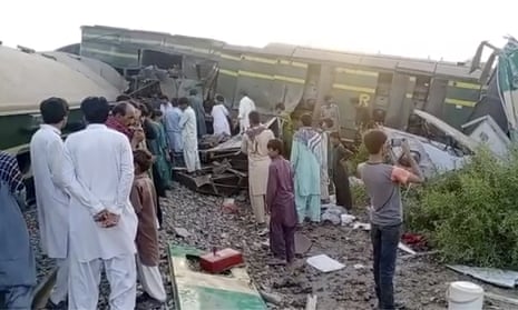People gathering at the site of the train collision in Ghotki, Pakistan