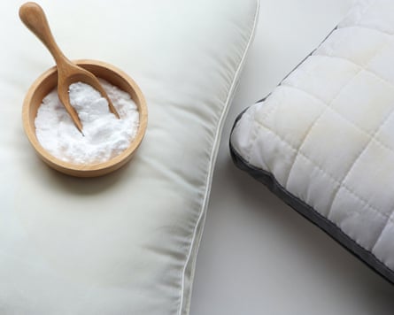 White pillow with yellow saliva stains and baking soda (sodium bicarbonate) on white background.