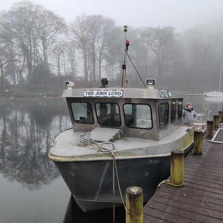 A boat tied up on a foggy day in Windermere