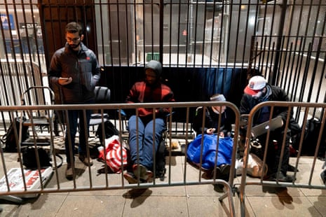 People, including members of the media, who had to wait in line overnight in an attempt to get a seat in the courtroom, queue outside of Manhattan Criminal Court in New York City on 4 April 2023.