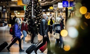 Travellers seen at Schiphol Airport, the Netherlands, on 30 November as the WHO issues a Covid-19 travel warning ahead of the holiday season in response to the Omicron variant. 