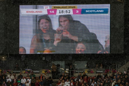 The crowd cheer as the big screen shows Ilona Maher of the USA drinking from two cups at the same time.