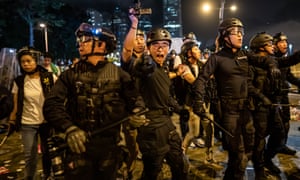 Police officers charge towards protesters after a rally against the extradition law proposal in Hong Kong