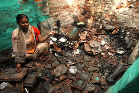 Kanchan Chowdhury, a Hindu woman, sitting inside her kitchen that was destroyed in an attack by a Muslim mob. Hours after a Hindu mob destroyed a Muslim locality in a fire and bomb attack, some Muslims attacked a few Hindu households in a retaliatory attack.