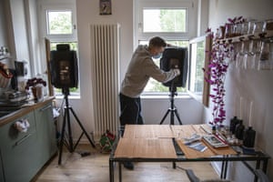 A member of the Windowflicks team prepares equipment prior to a movie projection on to the wall of a residential building in Berlin, Germany