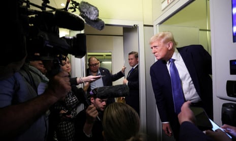 US President Donald Trump speaking to reporters on Air Force One on his return to Washington, DC