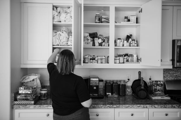 May, who lives by the forthcoming warehouses, goes through a cabinet filled with the prescribed medications that she needs to take daily.