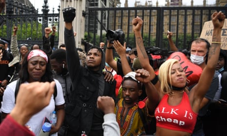 BRITAIN-US-POLITICS-RACE-PROTEST<br>Protestors including British actor John Boyega (C) raise their fists in Parliament square during an anti-racism demonstration in London, on June 3, 2020, after George Floyd, an unarmed black man died after a police officer knelt on his neck during an arrest in Minneapolis, USA. - Londoners defied coronavirus restrictions and rallied on Wednesday in solidarity with protests raging across the United States over the death of George Floyd, an unarmed black man who died during an arrest on May 25. (Photo by DANIEL LEAL-OLIVAS / AFP) (Photo by DANIEL LEAL-OLIVAS/AFP via Getty Images)