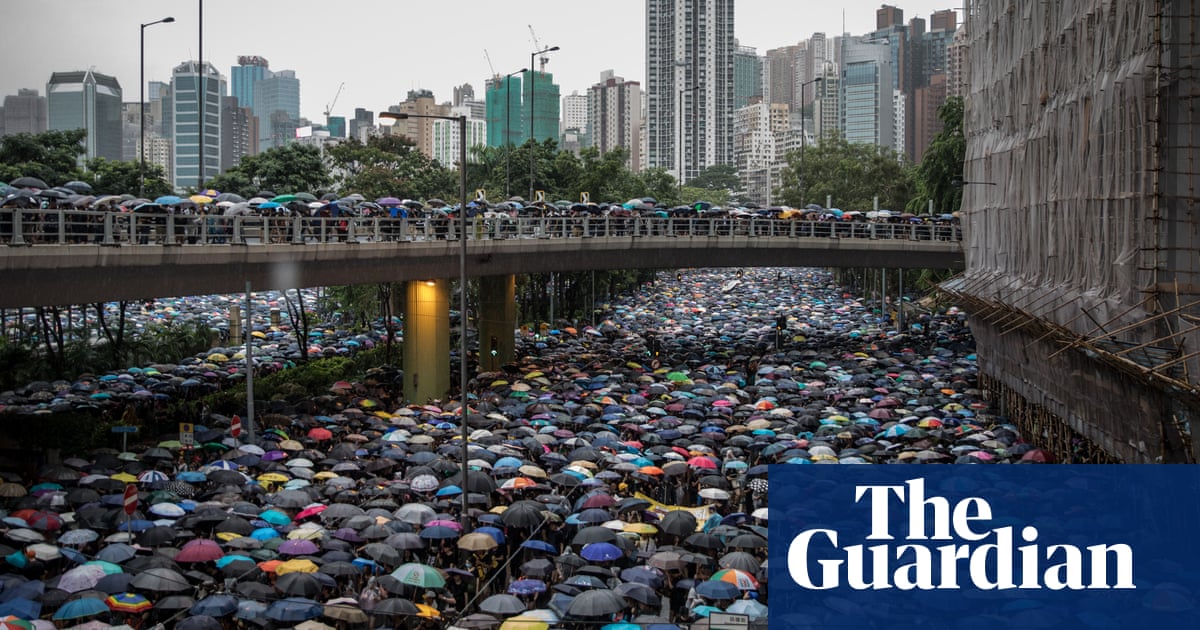 Hong Kong: 1.7m people defy police to march in pouring rain