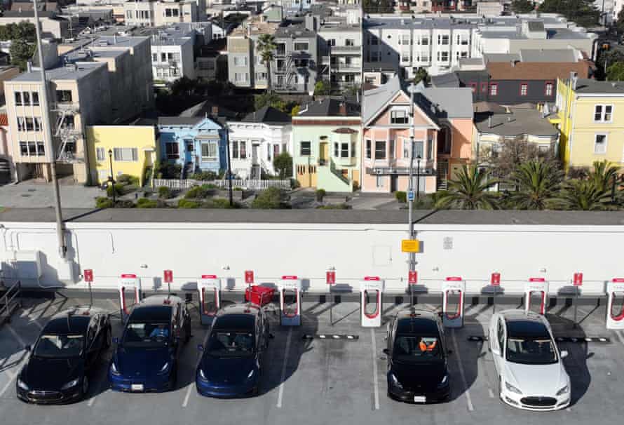 Tesla cars recharge their batteries at the Geary Boulevard Supercharger in San Francisco.