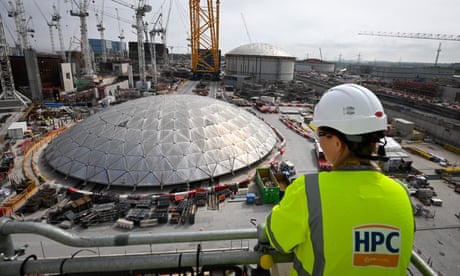 A worker looks at construction work at Hinkley Point C nuclear power station in Bridgwater, England.