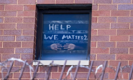 Signs pleading for help are seen in the windows at the Cook county jail complex in Chicago, Illinois, on 9 April. 