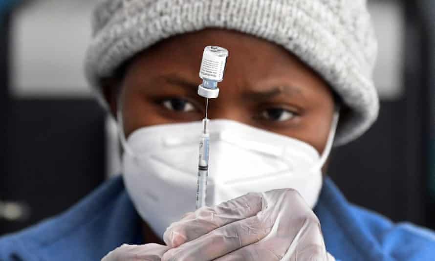 A nurse prepares the Pfizer Covid-19 vaccine at a public housing project pop-up site targeting vulnerable communities in Los Angeles, California.