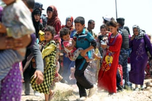 Families flee the besieged city, following a series of airstrikes targeting Isis positions