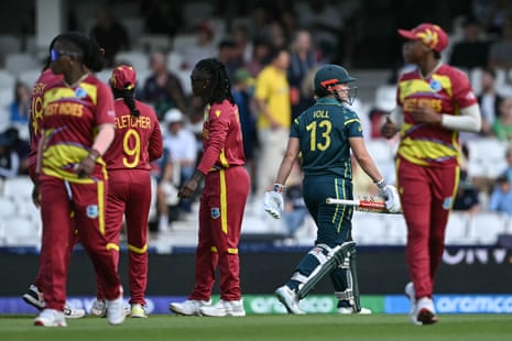 West Indies players celebrate as Australia's Georgia Voll walks off.