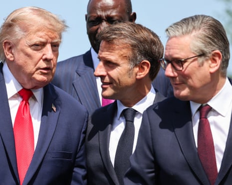 Donald Trump speaks with Emmanuel Macron, next to Keir Starmer