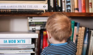 Ideal home … a child looks at some of the books on the family shelves.