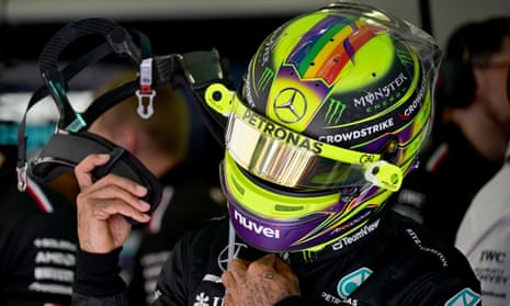 Lewis Hamilton puts on his helmet before the first practice session of the Bahrain Grand Prix.