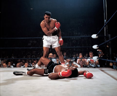 Muhammad Ali standing in the boxing ring over Sonny Liston on the canvas at the 1965 World Heavyweight Title.