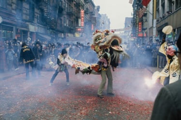 People dance with a dragon costume on a street