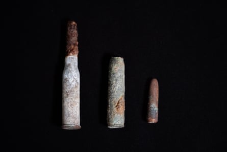 A closeup of bullets lined up on a black background