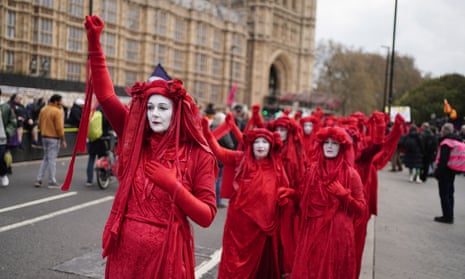 The Red Rebel Brigade join Extinction Rebellion demonstrators in Westminster, London.