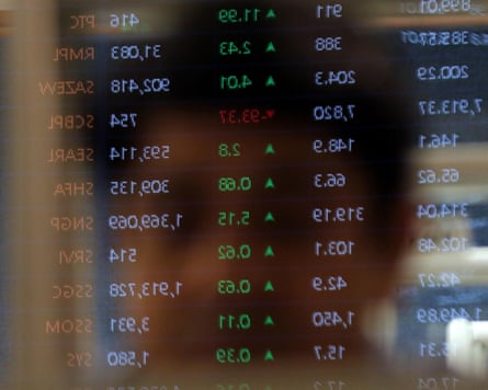 A trader monitors share prices at the Pakistan Stock Exchange (PSX) in Karachi, Pakistan