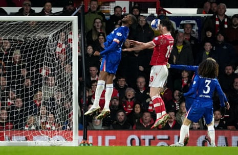 Wrexham's Kieffer Moore heads into Chelsea’s Tosin Adarabioyo.