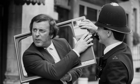 Terry Wogan jokes with a police officer