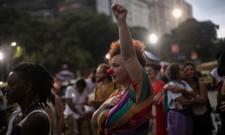 A woman wearing a clown nose raises her fist during a protest against the death of Julieta Hernández and violence against women, in Rio de Janeiro last week.