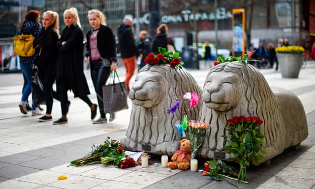 Flowers and candles at a makeshift memorial near the Stockholm attack site.