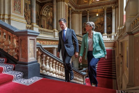 Mark Rutte and Yvette Cooper ascend a palatial staircase in the Foreign Office