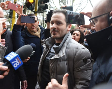 Andrea Sempio is swarmed by photographers outside a police station last year