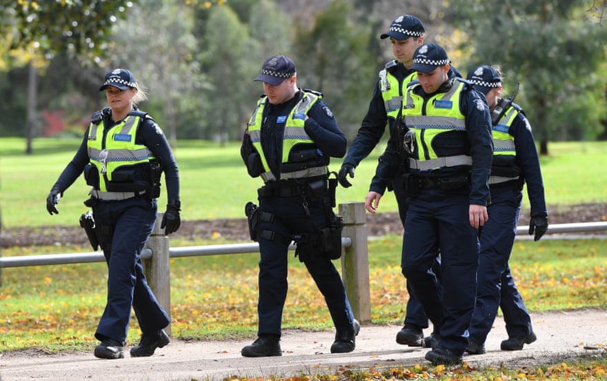 Police on patrol near a growing makeshift memorial for Eurydice Dixon at the Princes Park.