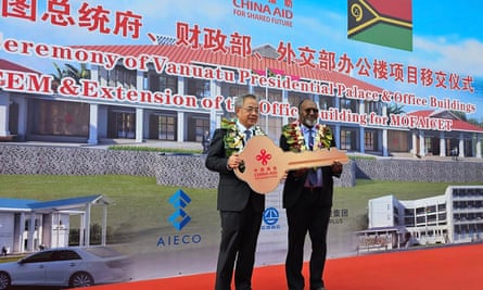 This handout picture released by the Vanuatu Ministry of the prime minister on 2 July 2024, shows Vanuatu prime minister Charlot Salwai (R) receiving a key from Hu Chunhua, vice-chairman of the 14th National Committee of the Chinese People�s Political Consultative Conference, during an official handover ceremony of the new presidential palace to the government of Vanuatu. China’s embassy said the project had gifted Vanuatu “another landmark building”, while symbolising a new “milestone” in their increasingly warm relationship