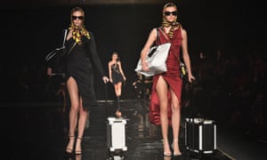 Versace models with carry-on trunks in New York.