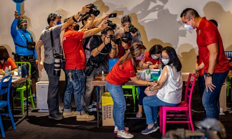 A healthcare worker administers a dose of Sinovac’s CoronaVac vaccine to a woman in the Philippines.