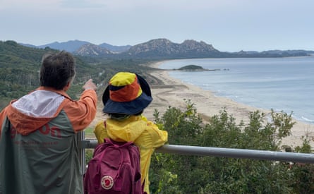 Tourists gaze towards North Korea and the Mount Kumgang range from the Goseong unification observation tower.