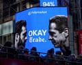 A Times Square billboard shows two mayoral candidates' faces facing each other with election odds