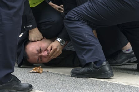 Policemen pin down and arrest a protester during a protest on a street in Shanghai on 27 Nov. 27, 2022. Authorities eased anti-virus rules in scattered areas but affirmed China’s severe “zero- COVID” strategy Monday after crowds demanded President Xi Jinping resign during protests against controls that confine millions of people to their homes. (AP Photo)