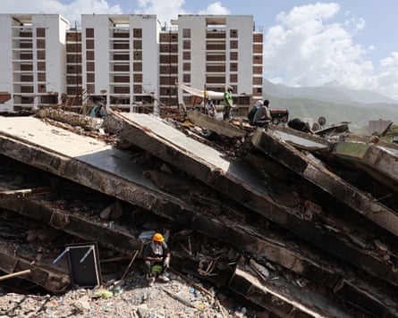 Rescuers continue the search for victims under the ruins of a building in La Guaira, Venezuela.
