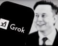 The Grok logo is displayed on a smartphone in front of a photograph of Elon Musk