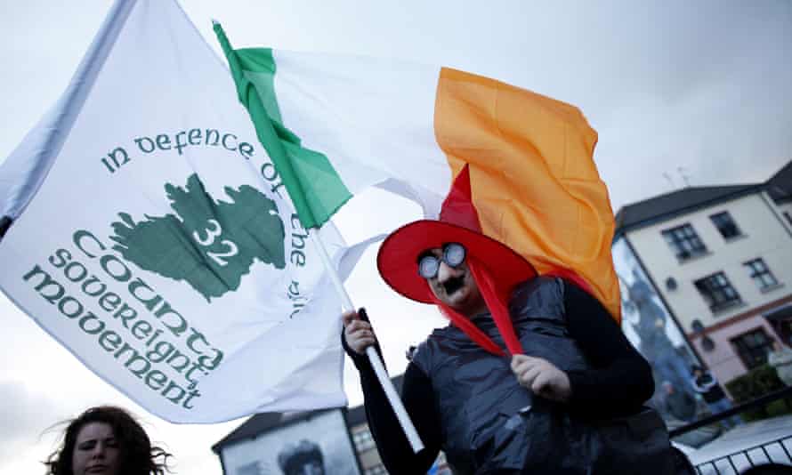A protester with republican and Irish flags at a demonstration marking the funeral of Margaret Thatcher in Derry, April 2013